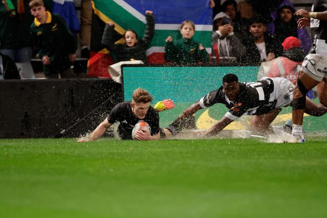 New Zealand's fullback Damian McKenzie scores a try during a rugby union tour match between The Sharks and New Zealand at Kings Park Stadium in Durban on August 11, 2026. (Photo by PHILL MAGAKOE / AFP)