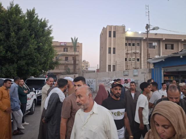 Relatives and friends wait outside the Al-Qassasin Specialized Hospital for news following a road accident in which some 18 people were killed, in the town of al-Qassasin, in the Ismailia Governorate, about 120 km east of Cairo on August 11, 2026. At least 18 people, many of them children aged 13 to 14, were killed on August 11, in northern Egypt when two pick-up trucks carrying agricultural day labourers crashed, a local medical source told AFP. (Photo by AFP)