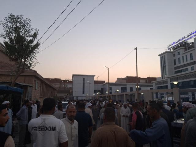 Relatives and friends wait outside the Al-Qassasin Specialized Hospital for news following a road accident in which some 18 people were killed, in the town of al-Qassasin, in the Ismailia Governorate, about 120 km east of Cairo on August 11, 2026. At least 18 people, many of them children aged 13 to 14, were killed on August 11, in northern Egypt when two pick-up trucks carrying agricultural day labourers crashed, a local medical source told AFP. (Photo by AFP)