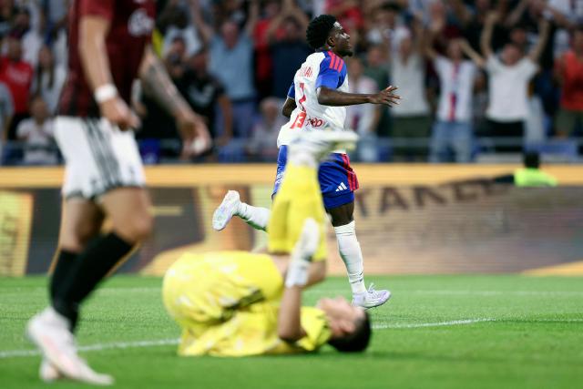 Lyon’s Ghanaian forward #7 Ernest Nuamah (C) celebrates after scoring his team's first goal during the UEFA Champions League third qualifying round - second leg football match between Olympique Lyonnais (OL) and Sparta Prague at Groupama Stadium in Decines-Charpieu, central-eastern France on August 11, 2026. (Photo by Alex MARTIN / AFP)