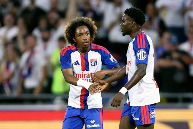 Lyon’s Ghanaian forward #7 Ernest Nuamah (R) celebrates with Lyon's Belgian forward #11 Malick Fofana (C) after scoring his team's first goal  during the UEFA Champions League third qualifying round - second leg football match between Olympique Lyonnais (OL) and Sparta Prague at Groupama Stadium in Decines-Charpieu, central-eastern France on August 11, 2026. (Photo by Alex MARTIN / AFP)