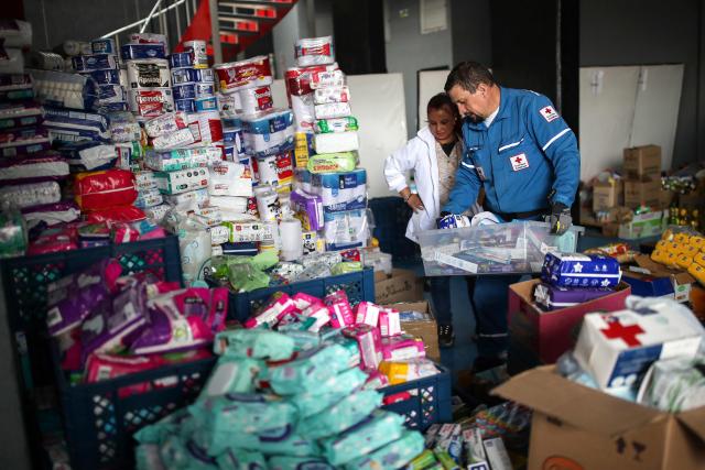 Colombian Red Cross members gather aid for earthquake victims in Bogota on August 11, 2026. Colombian volunteers and rescuers cleared rubble with their bare hands to search for survivors early on August 11 after the country's strongest earthquake in a decade killed at least 169 people and smashed dozens of buildings. (Photo by ESTEBAN VEGA LA-ROTTA / AFP)