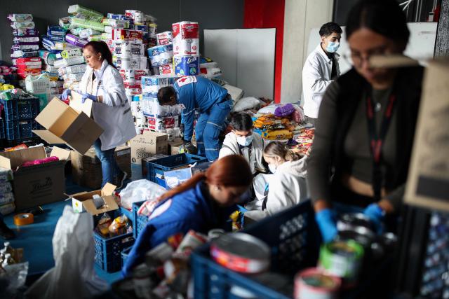 Colombian Red Cross members gather aid for earthquake victims in Bogota on August 11, 2026. Colombian volunteers and rescuers cleared rubble with their bare hands to search for survivors early on August 11 after the country's strongest earthquake in a decade killed at least 169 people and smashed dozens of buildings. (Photo by ESTEBAN VEGA LA-ROTTA / AFP)