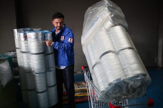 A Colombian Red Cross member gathers aid for earthquake victims in Bogota on August 11, 2026. Colombian volunteers and rescuers cleared rubble with their bare hands to search for survivors early on August 11 after the country's strongest earthquake in a decade killed at least 169 people and smashed dozens of buildings. (Photo by ESTEBAN VEGA LA-ROTTA / AFP)