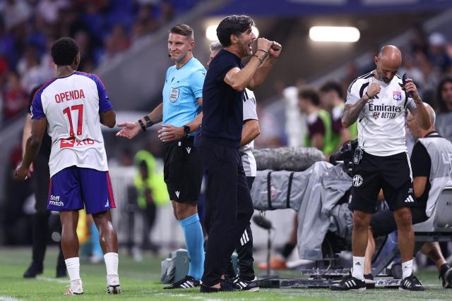 Lyon's Portuguese head coach Paulo Fonseca (C) celebrates his team's victory at the end of the UEFA Champions League third qualifying round - second leg football match between Olympique Lyonnais (OL) and Sparta Prague at Groupama Stadium in Decines-Charpieu, central-eastern France on August 11, 2026. (Photo by Alex MARTIN / AFP)