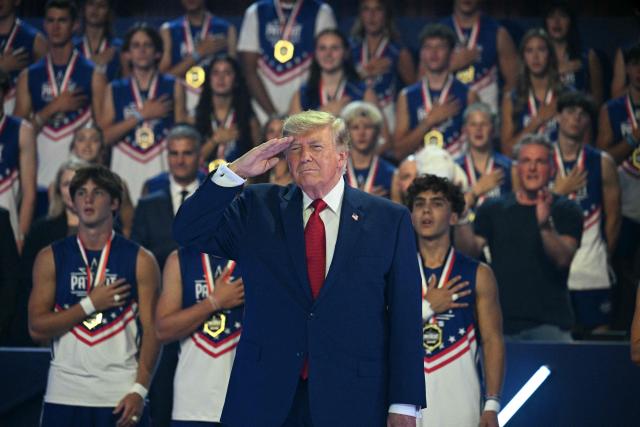 US President Donald Trump salutes before the 2026 Patriot Games finals at Spire Academy in Geneva, Ohio on August 11, 2026. (Photo by Jim WATSON / AFP)