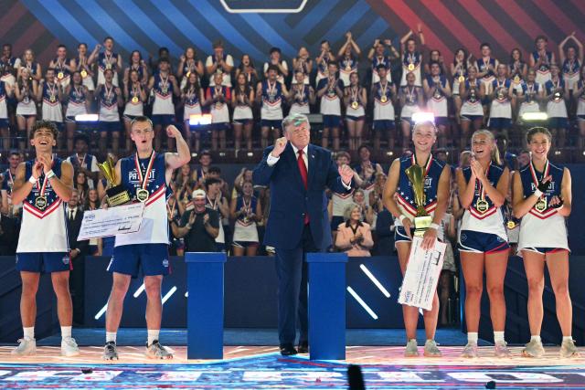 US President Donald Trump dances onstage next to participants during the 2026 Patriot Games finals at Spire Academy in Geneva, Ohio on August 11, 2026. (Photo by Jim WATSON / AFP)