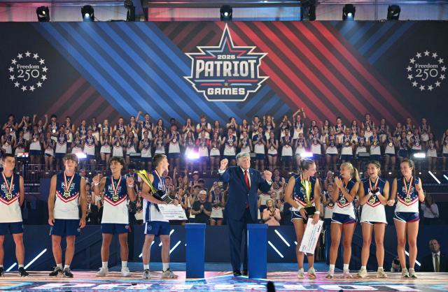 US President Donald Trump dances onstage next to participants during the 2026 Patriot Games finals at Spire Academy in Geneva, Ohio on August 11, 2026. (Photo by Jim WATSON / AFP)