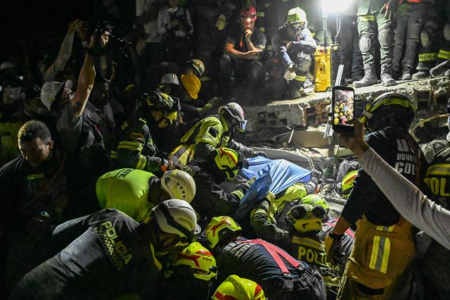 Firefighters and rescue teams carry survivor Daniela Andrea Largo Sanchez out of the rubble of a collapsed building after an earthquake in Cali, Colombia on August 11, 2026. Colombian volunteers and rescuers cleared rubble with their bare hands to search for survivors early on August 11 after the country's strongest earthquake in a decade killed at least 169 people and smashed dozens of buildings. (Photo by David SALAZAR / AFP)