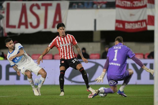 Universidad Catolica's goalkeeper #1 Vicente Bernedo stops the ball past teammate Argentine defender #2 Daniel Gonzalez (L) and Estudiantes' forward #32 Joaquin Correa during the first leg of the Copa Libertadores round of 16 football match between Argentina's Estudiantes de La Plata and Chile's Universidad Catolica at the Jorge Luis Hirschi stadium in La Plata, Buenos Aires province, Argentina on August 11, 2026. (Photo by JUAN MABROMATA / AFP)
