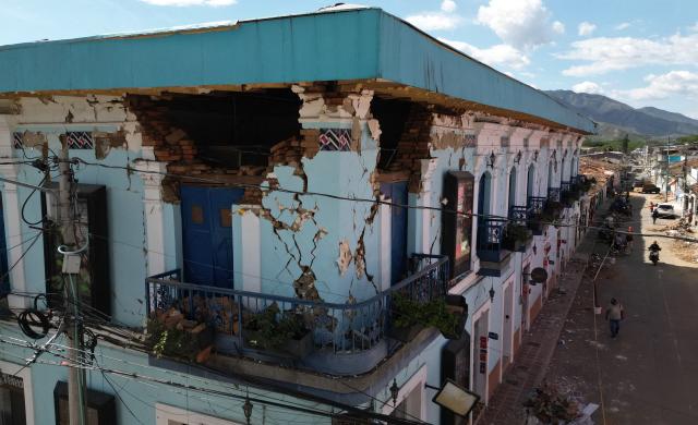 A destroyed house is pictured after an earthquake in Roldanillo, Valle del Cauca, Colombia on August 11, 2026. Rescuers, soldiers and volunteers searched through collapsed apartment blocks and office buildings across western Colombia, racing to find survivors after the country's strongest earthquake in a century killed at least 241 people and left many more homeless. (Photo by Raul ARBOLEDA / AFP)