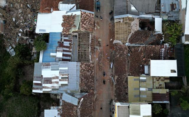 Aerial view shows destroyed houses after an earthquake in El Cairo, Valle del Cauca, Colombia on August 11, 2026. Rescuers, soldiers and volunteers searched through collapsed apartment blocks and office buildings across western Colombia, racing to find survivors after the country's strongest earthquake in a century killed at least 241 people and left many more homeless. (Photo by Raul ARBOLEDA / AFP)