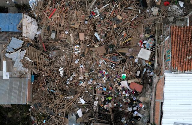 Aerial view shows a destroyed house after an earthquake in El Cairo, Valle del Cauca, Colombia on August 11, 2026. Rescuers, soldiers and volunteers searched through collapsed apartment blocks and office buildings across western Colombia, racing to find survivors after the country's strongest earthquake in a century killed at least 241 people and left many more homeless. (Photo by Raul ARBOLEDA / AFP)