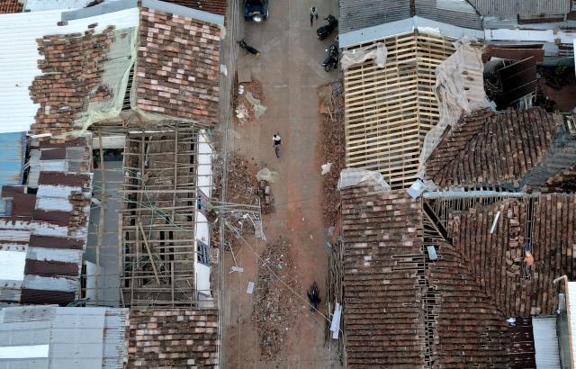 Aerial view shows destroyed houses after an earthquake in El Cairo, Valle del Cauca, Colombia on August 11, 2026. Rescuers, soldiers and volunteers searched through collapsed apartment blocks and office buildings across western Colombia, racing to find survivors after the country's strongest earthquake in a century killed at least 241 people and left many more homeless. (Photo by Raul ARBOLEDA / AFP)