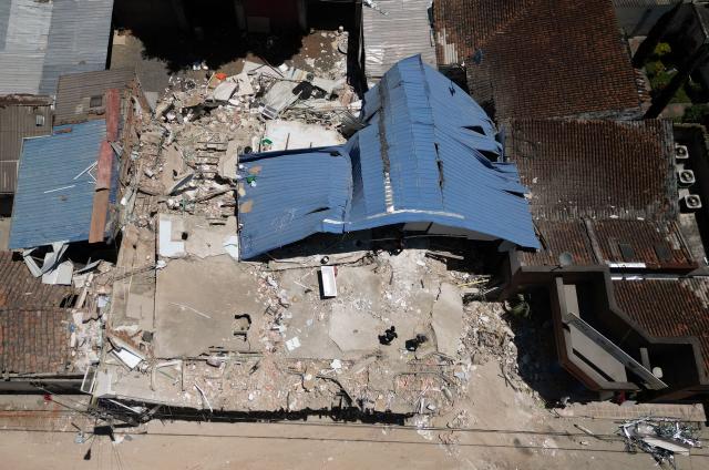 Aerial view shows a destroyed house after an earthquake in Zarzal, Valle del Cauca, Colombia on August 11, 2026. Rescuers, soldiers and volunteers searched through collapsed apartment blocks and office buildings across western Colombia, racing to find survivors after the country's strongest earthquake in a century killed at least 241 people and left many more homeless. (Photo by Raul ARBOLEDA / AFP)
