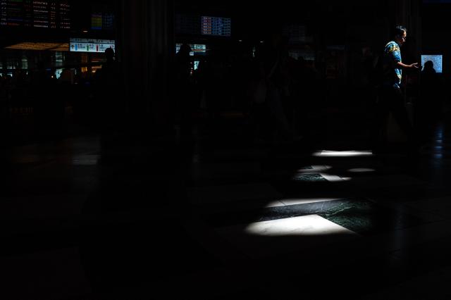Commuters walk in Tokyo station on August 12, 2026. (Photo by Philip FONG / AFP)