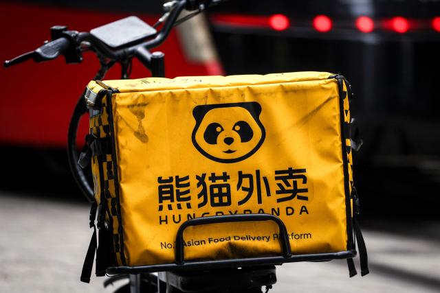 (FILES) A HungryPanda food delivery electric bike sits on a footpath in central Sydney on February 19, 2026. Hundreds of thousands of gig workers in Australia have been granted a huge pay rise from August 17, 2026 under a decision by the country's workplace relations tribunal lauded as "world-leading". (Photo by DAVID GRAY / AFP)
