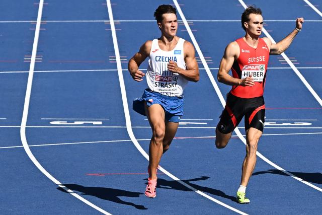 Czech Republic's Vilem Strasky (L) crosses the finish line to arrive first past Switzerland's Andrin Huber (R) in the men's decathlon 100m heat 2 during the European Athletics Championships at Alexander Stadium in Birmingham on August 12, 2026. (Photo by Paul ELLIS / AFP)