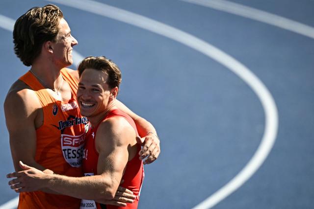 Second-placed Netherlands' Jeff Tesselaar congratulates first-placed Switzerland's Nino Portmann after competing in the men's decathlon 100m heats during the European Athletics Championships at Alexander Stadium in Birmingham on August 12, 2026. (Photo by Paul ELLIS / AFP)