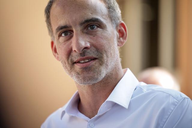 French politician, centre-left party Place publique's leader and MEP Raphael Glucksmann looks on as he meets with the residents affected by last year's wildfire, in Jonquiere, south-western France, on August 12, 2026. (Photo by Valentine CHAPUIS / AFP)