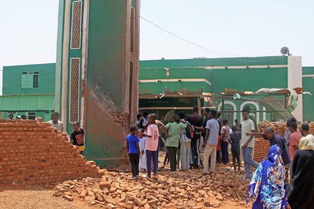 People gather to clear debris from the complex of a mosque that was hit by a drone strike in the El-Droshab area of Khartoum North, on August 12, 2026. Sudan's paramilitary Rapid Support Forces launched drone strikes on capital Khartoum and other army-controlled cities on August 12, in what appeared to be their largest coordinated attack in months. (Photo by Ebrahim Hamid / AFP)