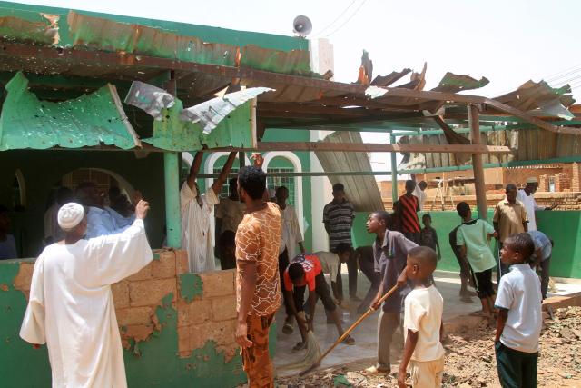 People clear the debris from the complex of a mosque that was hit by a drone strike in the El-Droshab area of Khartoum North, on August 12, 2026. Sudan's paramilitary Rapid Support Forces launched drone strikes on capital Khartoum and other army-controlled cities on August 12, in what appeared to be their largest coordinated attack in months. (Photo by Ebrahim Hamid / AFP)