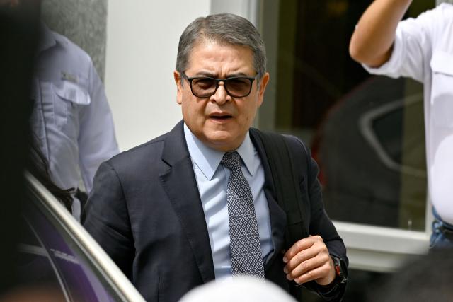 Former Honduras' President (2014-2022) Juan Orlando Hernandez arrives for a hearing in a trial for fraud and money-laundering at the Supreme Court of Justice in Tegucigalpa on August 12, 2026. Hernandez is accused of fraud and money-laundering charges, which he denies, claiming to be the continued victim of "persecution." A judge suspended an arrest warrant against him, as he agreed to appear voluntarily after US President Donald Trump pardoned him a 45-year prison sentence last year. (Photo by Orlando SIERRA / AFP)