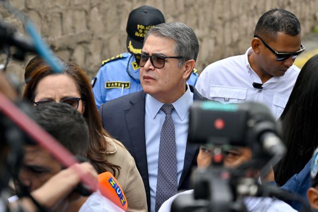 Former Honduras' President (2014-2022) Juan Orlando Hernandez arrives for a hearing in a trial for fraud and money-laundering at the Supreme Court of Justice in Tegucigalpa on August 12, 2026. Hernandez is accused of fraud and money-laundering charges, which he denies, claiming to be the continued victim of "persecution." A judge suspended an arrest warrant against him, as he agreed to appear voluntarily after US President Donald Trump pardoned him a 45-year prison sentence last year. (Photo by Orlando SIERRA / AFP)