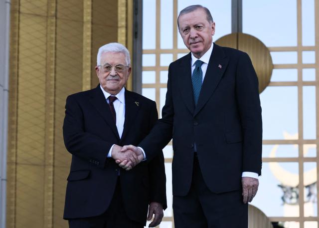Turkey's President Recep Tayyip Erdogan (L) welcomes Palestinian President Mahmoud Abbas (R) during a welcoming ceremony at the Presidential Complex in Ankara on August 12, 2026. (Photo by Adem ALTAN / AFP)