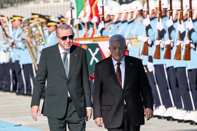 Turkey's President Recep Tayyip Erdogan (L) welcomes Palestinian President Mahmoud Abbas (R) during a welcoming ceremony at the Presidential Complex in Ankara on August 12, 2026. (Photo by Adem ALTAN / AFP)