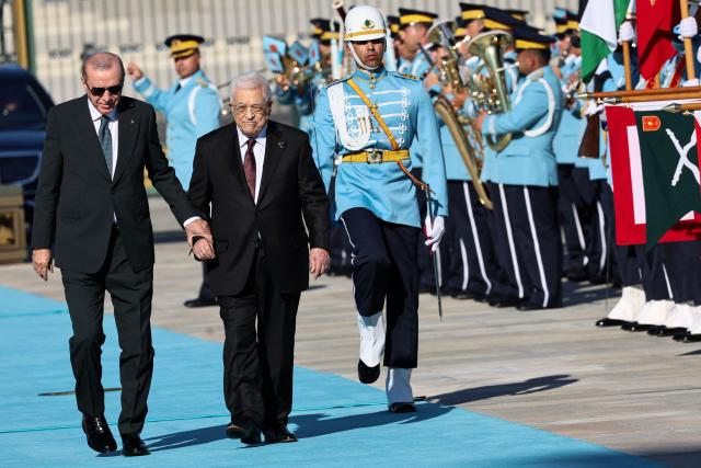 Turkey's President Recep Tayyip Erdogan (L) welcomes Palestinian President Mahmoud Abbas (R) during a welcoming ceremony at the Presidential Complex in Ankara on August 12, 2026. (Photo by Adem ALTAN / AFP)