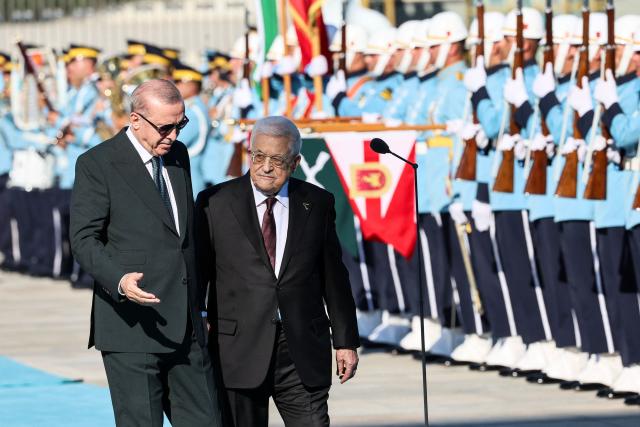 Turkey's President Recep Tayyip Erdogan (L) welcomes Palestinian President Mahmoud Abbas (R) during a welcoming ceremony at the Presidential Complex in Ankara on August 12, 2026. (Photo by Adem ALTAN / AFP)