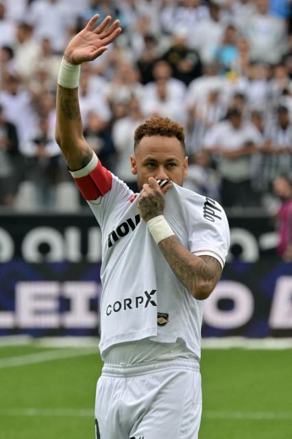 (FILES) Santos' forward #10 Neymar waves to the fans ahead of the Brazilian league football match between Santos and Coritiba at the Neo Quimica Arena in Sao Paulo, Brazil, on May 17, 2026. Santos will face Ecuador's Macara in the first leg of the Copa Sudamericana round of 16 on August 14, 2026, while Neymar is being linked to Inter Miami, where two former teammates from his time at FC Barcelona play: Lionel Messi and Luis Suarez. Neymar's contract with the Brazilian club expires on December 31, and the 34-year-old forward has given no indication of his future plans. (Photo by NELSON ALMEIDA / AFP)