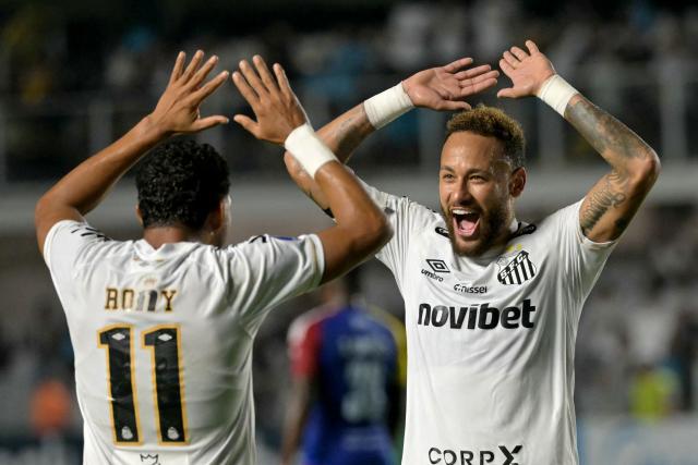 (FILES) Santos' forward #11 Rony celebrates with teammate forward #10 Neymar after scoring his team's fourth goal during the second leg of the Copa Sudamericana knockout round play-off football match between Brazil's Santos and Venezuela's Universidad Central at the Urbano Caldeira stadium, in Santos, state of Sao Paulo, Brazil, on July 28, 2026. Santos will face Ecuador's Macara in the first leg of the Copa Sudamericana round of 16 on August 14, 2026, while Neymar is being linked to Inter Miami, where two former teammates from his time at FC Barcelona play: Lionel Messi and Luis Suarez. Neymar's contract with the Brazilian club expires on December 31, and the 34-year-old forward has given no indication of his future plans. (Photo by NELSON ALMEIDA / AFP)