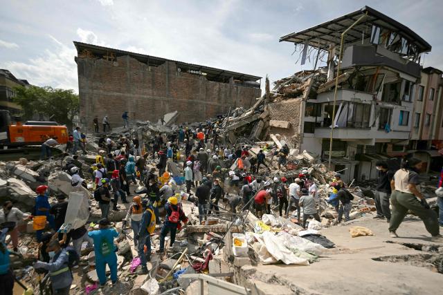 Rescuers search for survivors amid the rubble of a collapsed building after an earthquake in Pereira, Colombia on August 12, 2026. Rescuers, soldiers and volunteers searched through collapsed apartment blocks and office buildings across western Colombia, racing to find survivors after the country's strongest earthquake in a century killed at least 239 people and left many more homeless on August 10, 2026. The 7.4-magnitude quake injured more than 1,670 people, according to a tally by municipal authorities. (Photo by Luis ACOSTA / AFP)