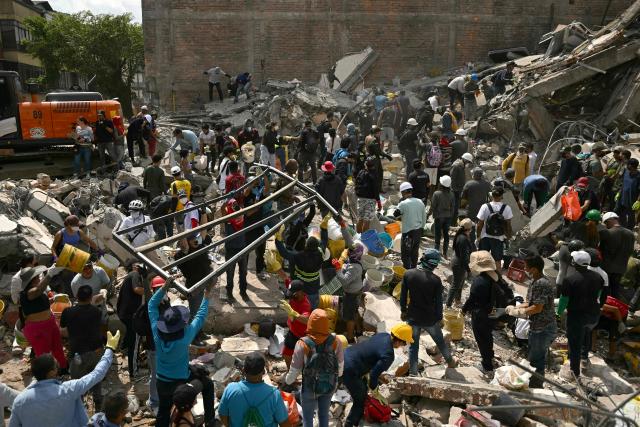 Rescuers search for survivors amid the rubble of a collapsed building after an earthquake in Pereira, Colombia on August 12, 2026. Rescuers, soldiers and volunteers searched through collapsed apartment blocks and office buildings across western Colombia, racing to find survivors after the country's strongest earthquake in a century killed at least 239 people and left many more homeless on August 10, 2026. The 7.4-magnitude quake injured more than 1,670 people, according to a tally by municipal authorities. (Photo by Luis ACOSTA / AFP)