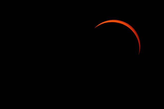 The moon passes over the sun's horizon during a partial solar eclipse in Rennes, western France, on August 12, 2026. In France, the solar eclipse was not total - after the total solar eclipse of 1999 France will not see another total eclipse for another 55 years in 2081. (Photo by Damien MEYER / AFP)