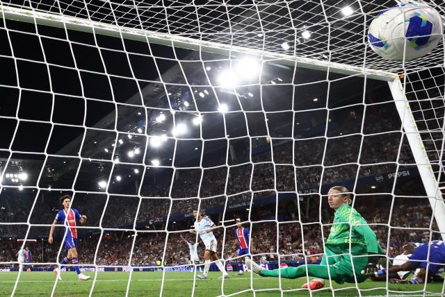 Aston Villa's English striker #39 Brian Madjo (R) scores the 1-1 goal past Paris Saint-Germain's Russian goalkeeper #39 Matvey Safonov during the UEFA Supercup football match between Champions League winners Paris Saint Germain (PSG) and Europa League winners Aston Villa in Salzburg, Austria on August 12, 2026. (Photo by FRANCK FIFE / AFP)