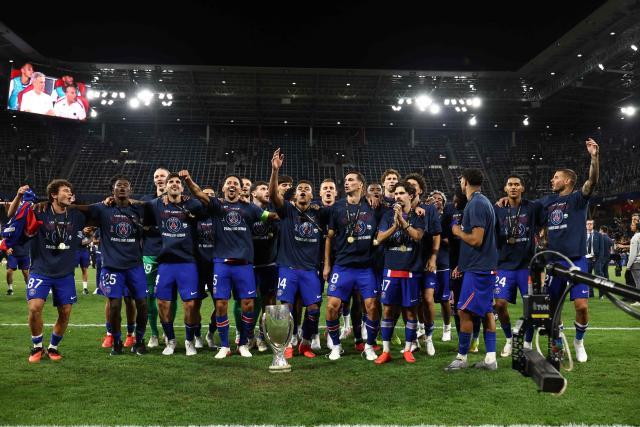 PSG players celebrate with the trophy after winning the UEFA Supercup football match between Champions League winners Paris Saint Germain (PSG) and Europa League winners Aston Villa in Salzburg, Austria on August 12, 2026. (Photo by FRANCK FIFE / AFP)