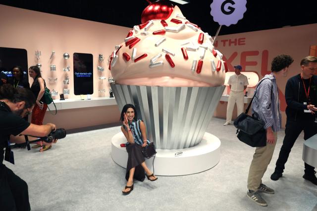 An attendee poses while using the newest Google Pixel 11 smartphone during the "Made by Google" product launch event in New York City on August 12, 2026. (Photo by TIMOTHY A. CLARY / AFP)