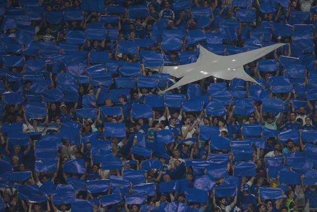 Cruzeiro fans cheer ahead of the first leg of the Copa Libertadores round of 16 football match between Brazilian teams Cruzeiro and Flamengo at the Mineirao stadium in Belo Horizonte, Minas Gerais state, Brazil, on August 12, 2026. (Photo by DOUGLAS MAGNO / AFP)
