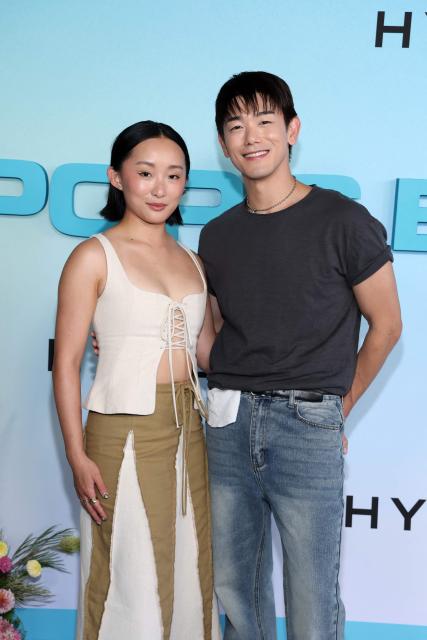 US actress Ji-young Yoo (L) and US singer/songwriter Eric Nam, of the upcoming coming-of-age musical drama film "K-Pop: The Debut", attend HYBE America's celebration of K-Pop's biggest weekend at the Grammy Museum in Los Angeles on August 12, 2026. (Photo by VALERIE MACON / AFP)