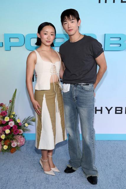 US actress Ji-young Yoo (L) and US singer/songwriter Eric Nam, of the upcoming coming-of-age musical drama film "K-Pop: The Debut", attend HYBE America's celebration of K-Pop's biggest weekend at the Grammy Museum in Los Angeles on August 12, 2026. (Photo by VALERIE MACON / AFP)