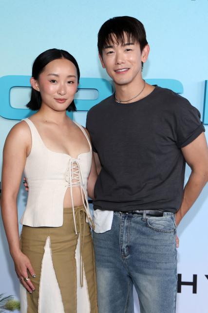 US actress Ji-young Yoo (L) and US singer/songwriter Eric Nam, of the upcoming coming-of-age musical drama film "K-Pop: The Debut", attend HYBE America's celebration of K-Pop's biggest weekend at the Grammy Museum in Los Angeles on August 12, 2026. (Photo by VALERIE MACON / AFP)