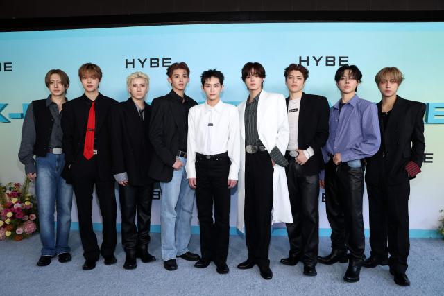 (L-R) Members of the Japanese boy band "&Team" Fuma, EJ, Yuma, Jo, Harua, K, Maki, Nicholas and Taki attend HYBE America's celebration of K-Pop's biggest weekend at the Grammy Museum in Los Angeles on August 12, 2026. (Photo by VALERIE MACON / AFP)