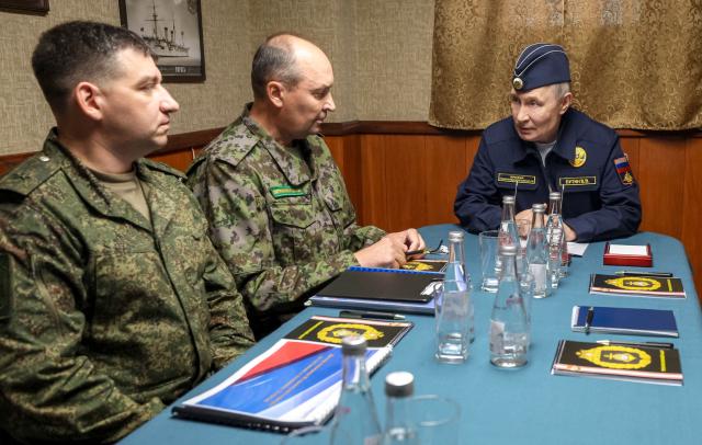 In this pool photograph distributed by the Russian state agency Sputnik, Russia's President Vladimir Putin holds a meeting on ensuring the security of Russia's eastern borders onboard the Russian Navy's guided missile cruiser Varyag on far eastern Sakhalin Island on August 13, 2026. (Photo by Gavriil Grigorov / POOL / AFP)