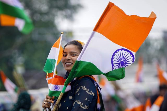 A vendor reacts while selling Indian national flags in Ajmer on August 13, 2026 ahead of the country's Independence Day celebrations. (Photo by Himanshu SHARMA / AFP)
