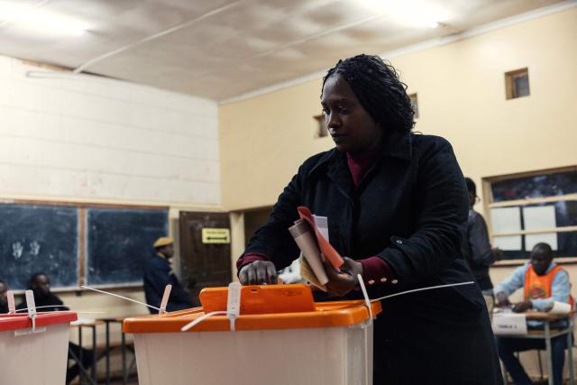 A woman casts her ballot at a polling station in Lusaka on August 13, 2026. Zambians went to the polls on August 13 with economic hardship testing President Hakainde Hichilema's record as he seeks a second term to govern the copper-rich nation. Polling stations in the southern African nation opened at 6:00 am (0400 GMT) and were due to close 12 hours later, with 8.7 million voters registered to cast their ballots. (Photo by GIANLUIGI GUERCIA / AFP)