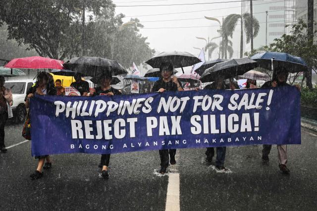 People march as they protest against Pax Silica, a US-led initiative, in Manila on August 13, 2026. (Photo by Jam STA ROSA / AFP)