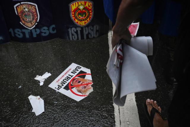 A ripped photo of US President Donald Trump is seen on the street during a protest against Pax Silica, a US-led initiative, in Manila on August 13, 2026. (Photo by Jam STA ROSA / AFP)